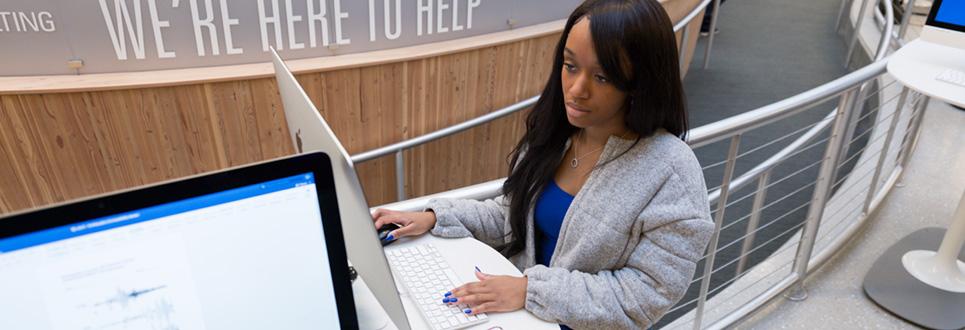 Student using computer at Angell Hall courtyard computing site